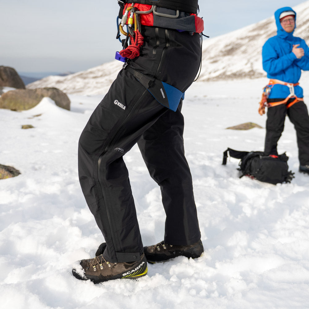 Women's Pinnacle waterproof trousers - side view showing full-length zip and active fit
