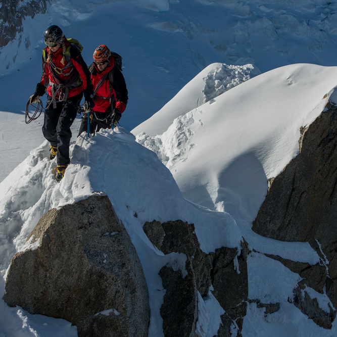 Iona Advanced trousers worn on mountain top in extreme conditions - with leg extenders and adjustable waist features