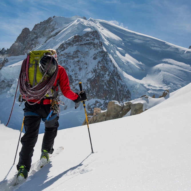 Women's Iona trousers worn outdoors on snowy mountain showing System Dual Protection waterproof performance